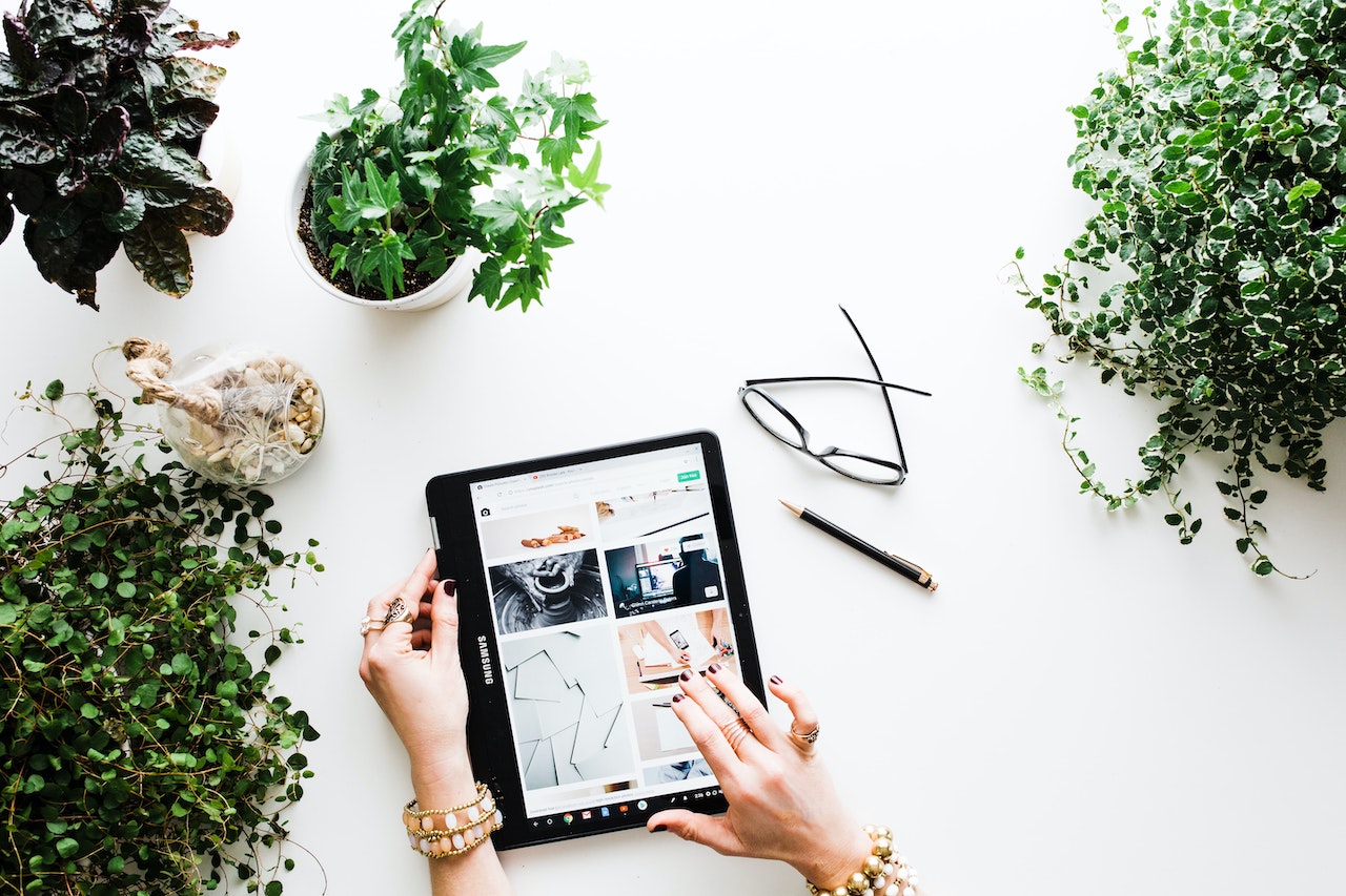 Tablet Using Digital Marketing Tools Surrounded by Plants